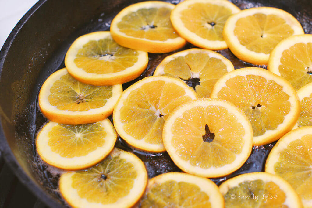 Brown sugar in melted butter in a cast iron pan covered with orange slices