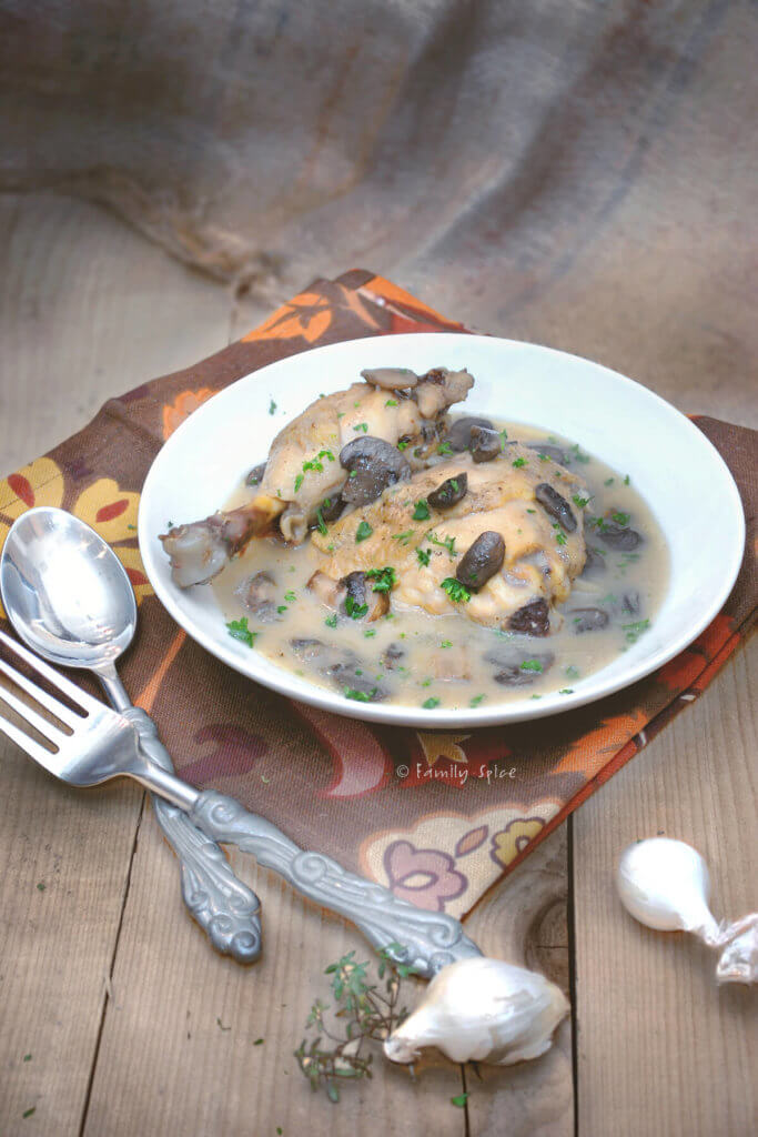 A bowl of chicken fricasse on a brown rustic background