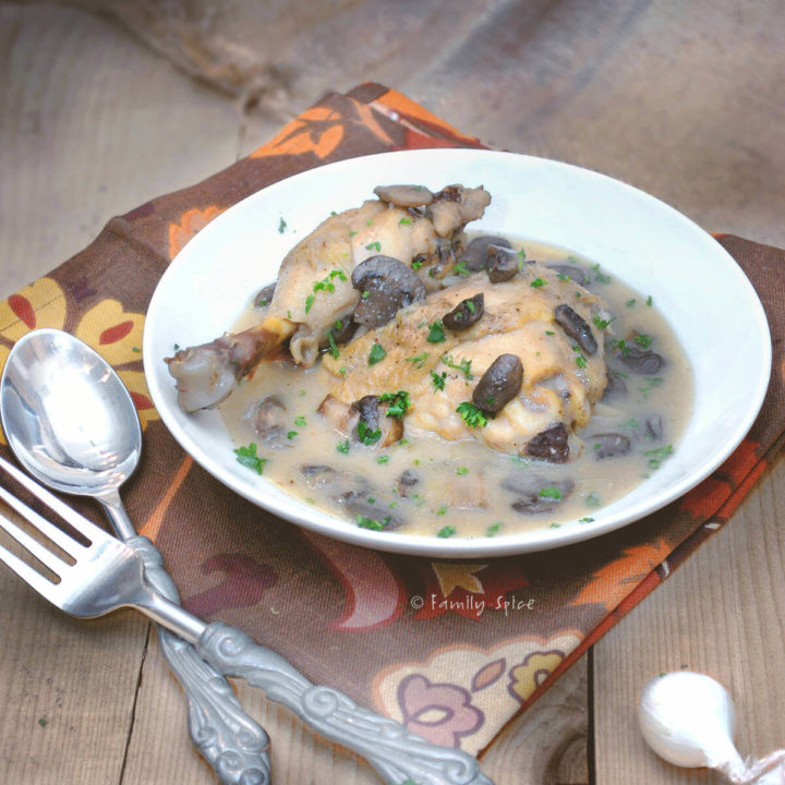 A bowl of chicken fricasse on a brown rustic background