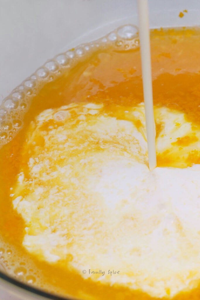 Adding heavy cream, orange zest and orange juice in the ice cream maker
