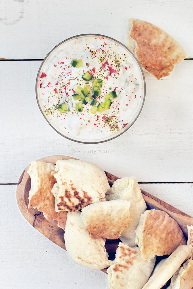 Overhead shot of Persian Yogurt with Cucumber (Mast-o Khiar) with Pita Bread by FamilySpice.com
