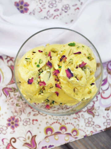 Top view of several scoops of Persian ice cream garnished with pistachios and rose petals