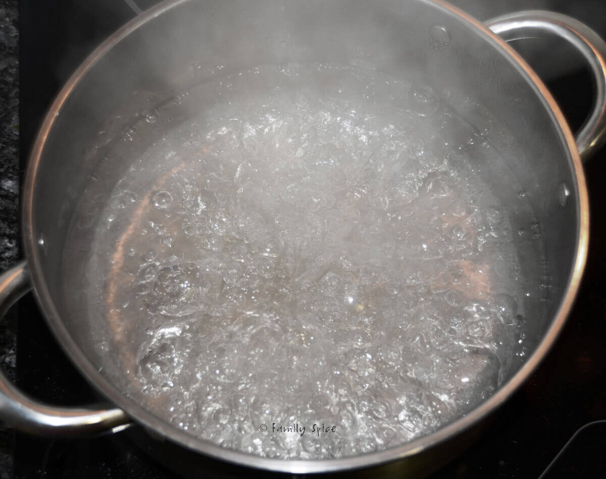 Closeup of a pot with simple syrup boiling in it