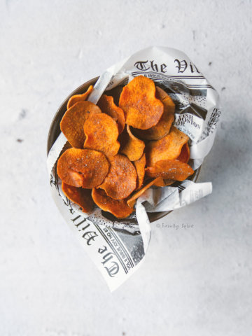 Top view of a metal container filled with baked sweet potato chips