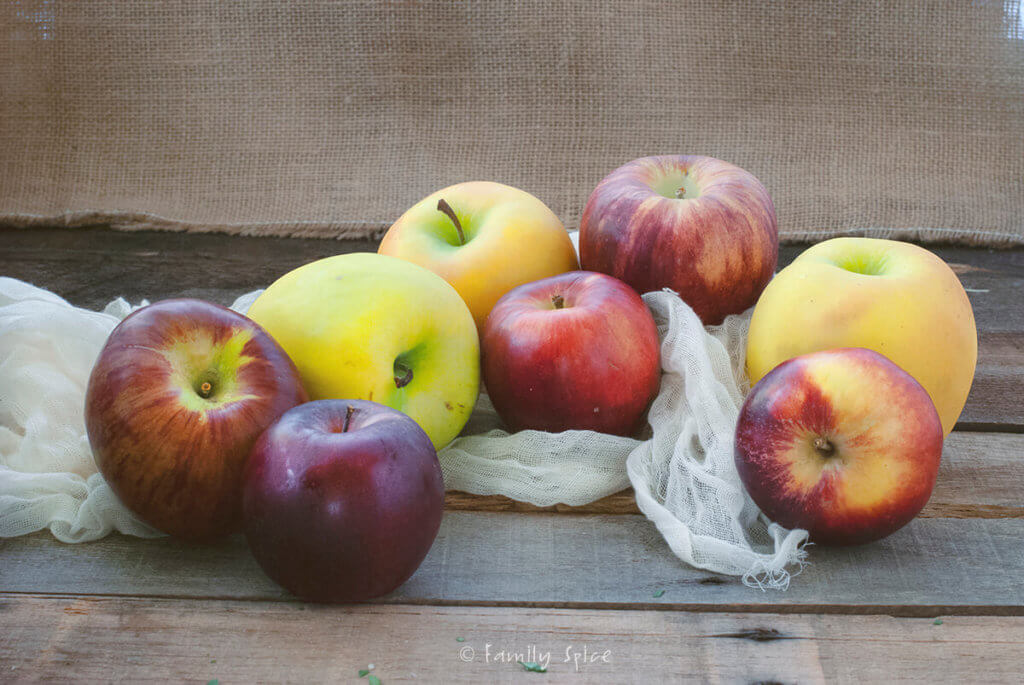 Assorted apples on a rustic background