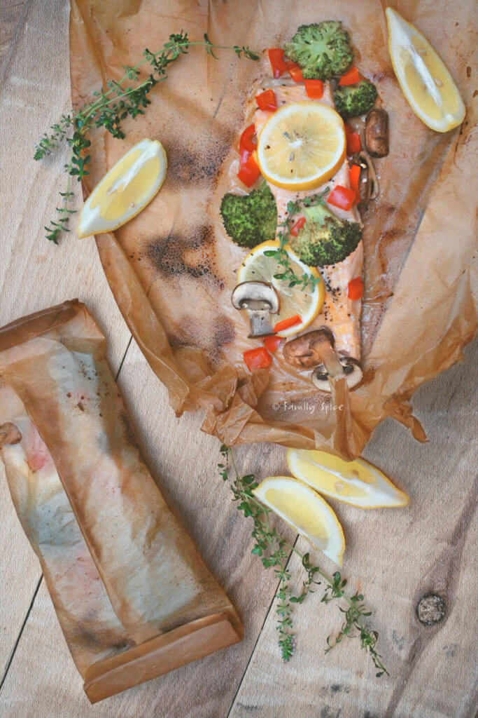 Top view of salmon cooked in parchment paper with vegetables