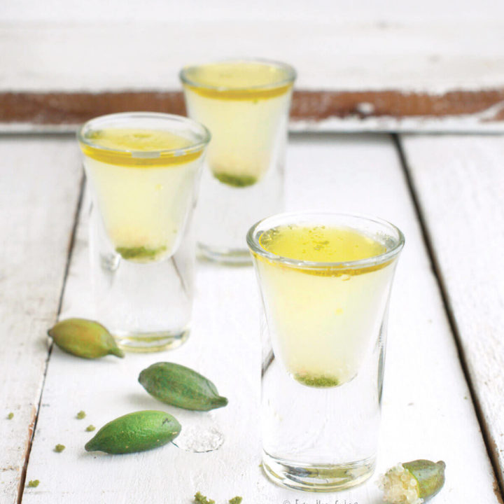 Three shot glasses with finger lime kamikaze shots with olive oil