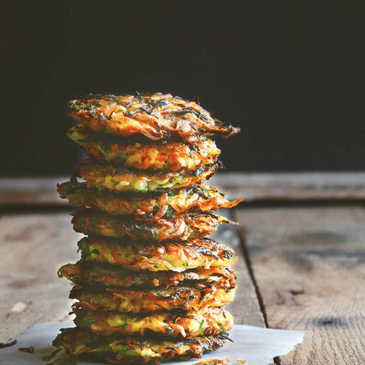 A stack of vegetable latkes on a dark and rustic background