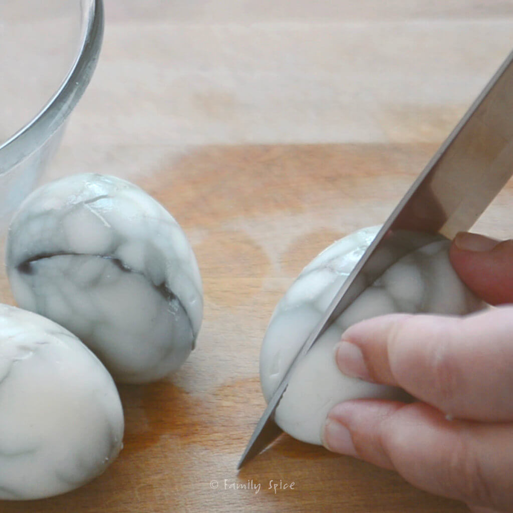 Cutting in half hard boiled eggs with web design on the whites