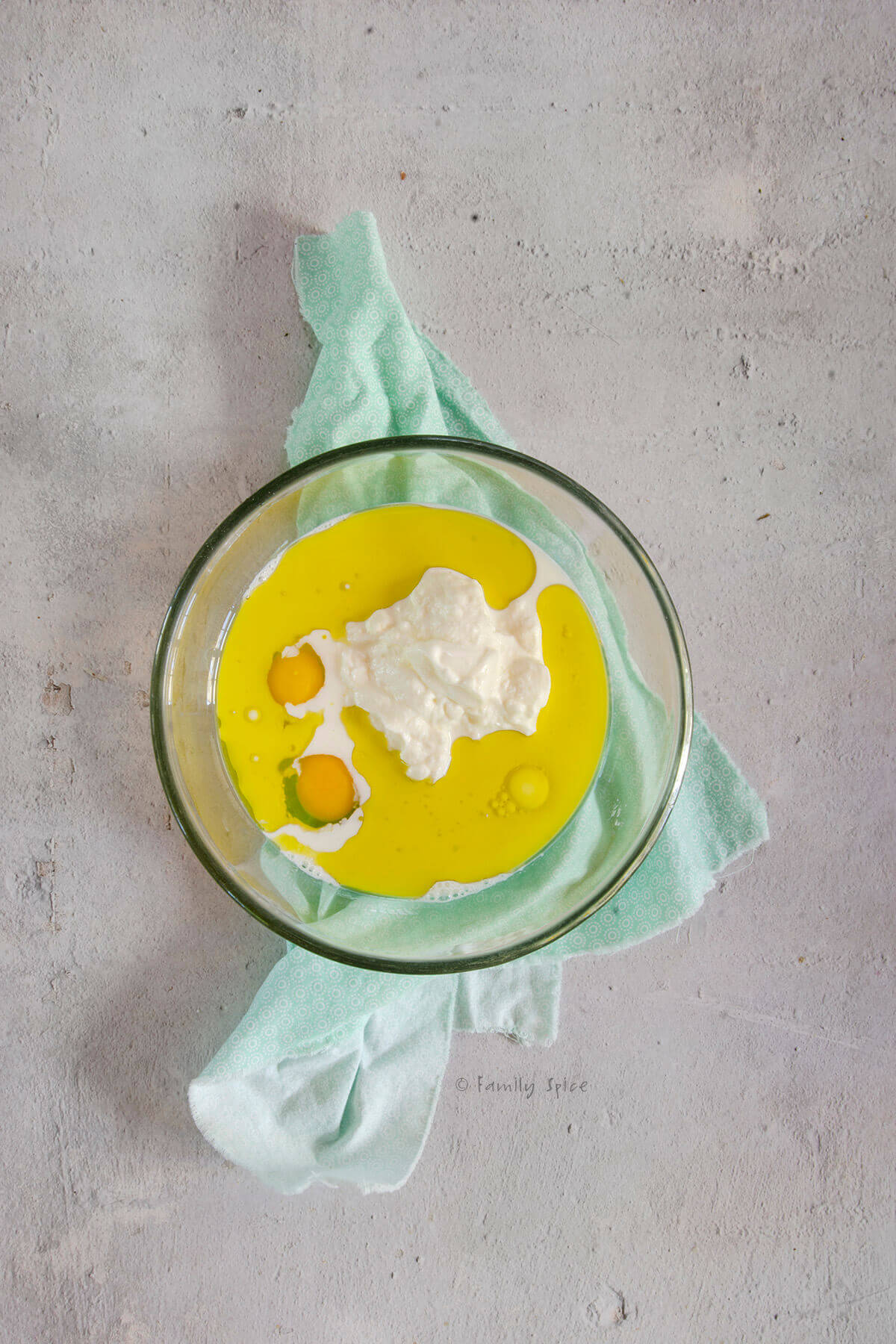 Olive oil, extra, yogurt and milk in a glass mixing bowl