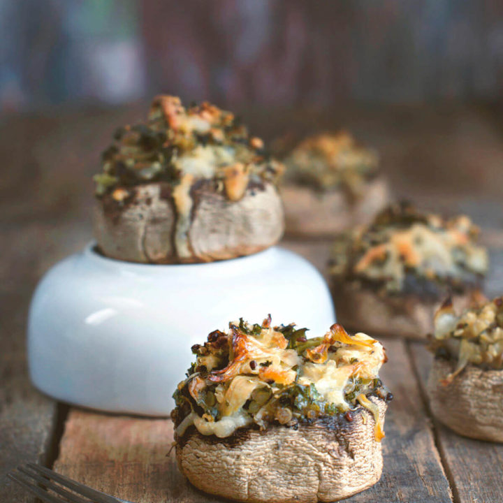 Closeup of quinoa and cheese stuffed mushrooms on a rustic backgroud