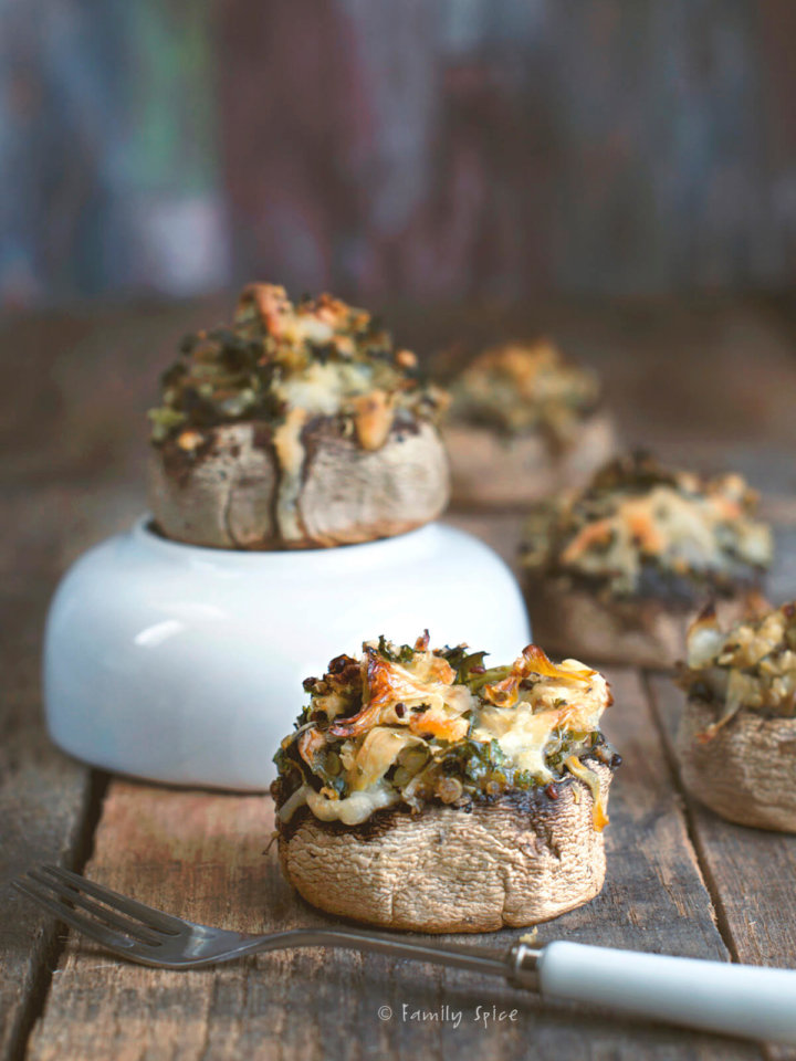 Closeup of quinoa and cheese stuffed mushrooms on a rustic backgroud