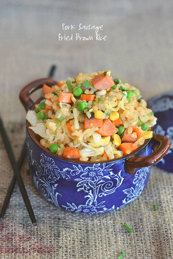 Closeup of fried brown rice with carrots, corn, peas and sausage by FamilySpice.com