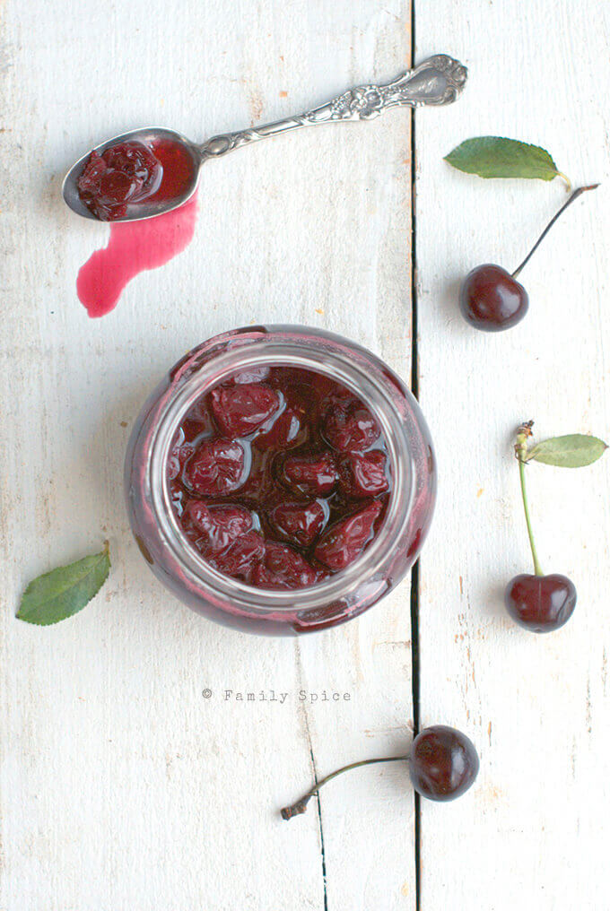 Overhead shot of a jar of Sour Cherry Jam (Moraba Albaloo) by FamilySpice.com