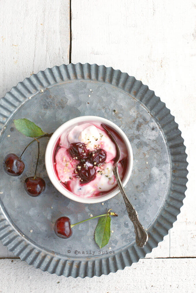 A bowl of yogurt with some Sour Cherry Jam (Moraba Albaloo) by FamilySpice.com