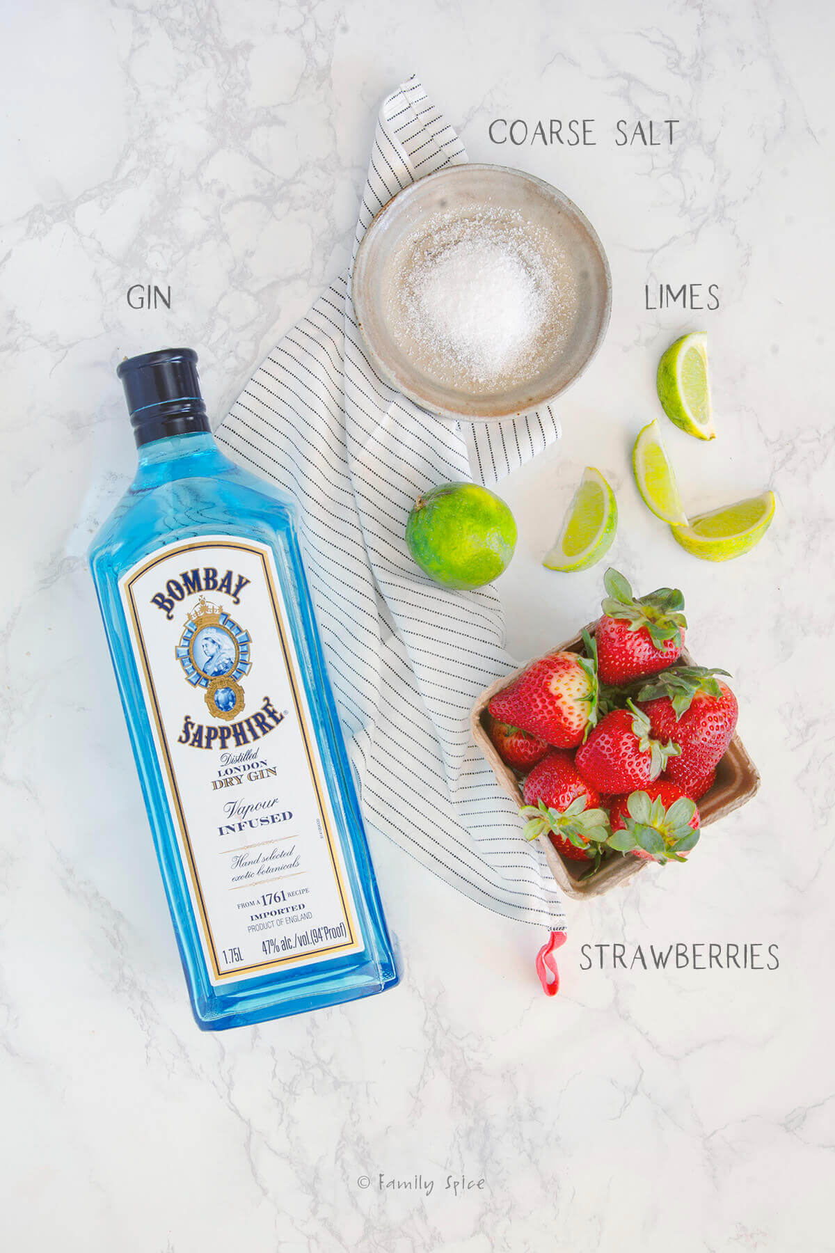 Ingredients labeled and needed to make a strawberry lime salty dog cocktail