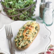 Closeup of kale twice baked potato on a white plate