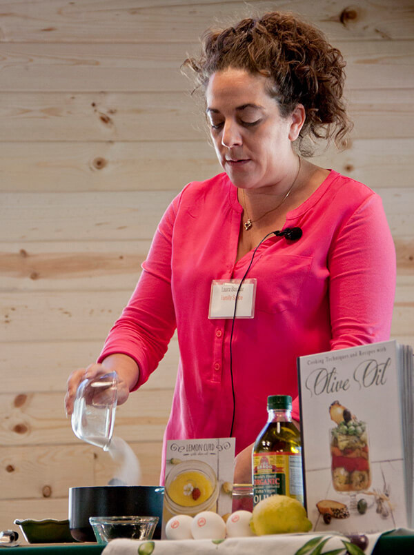 Laura Bashar doing a cooking demo on how to make olive oil lemon curd