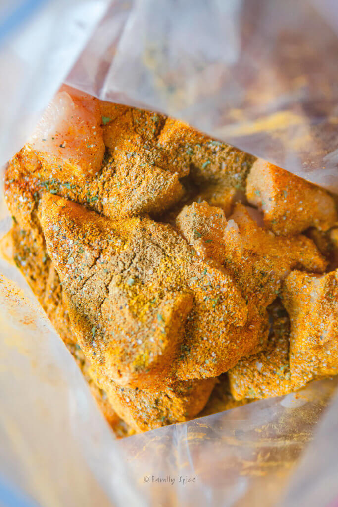 Chicken cubes seasoned with shawarma spice mix in a resealable bag