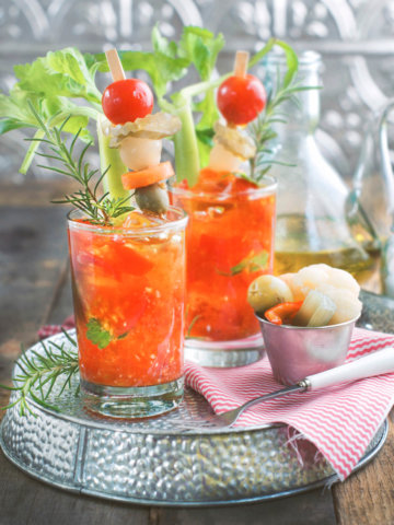 Two glasses of cherry tomato bloody marys with pickled garnishings