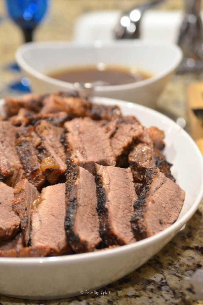 A platter of slices of smoked beef brisket