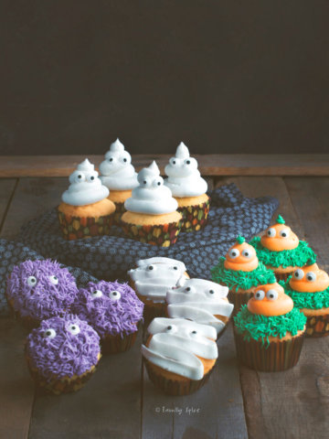 Assortments of halloween cupcakes on a dark rustic background