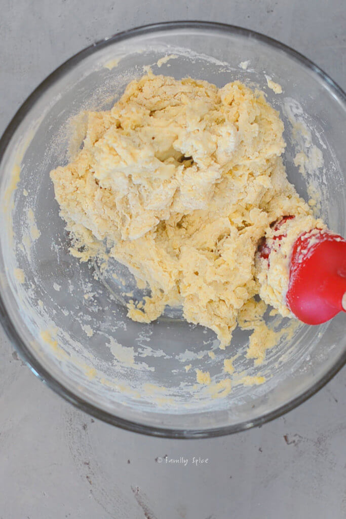Mixing olive oil scone dough in a glass mixing bowl