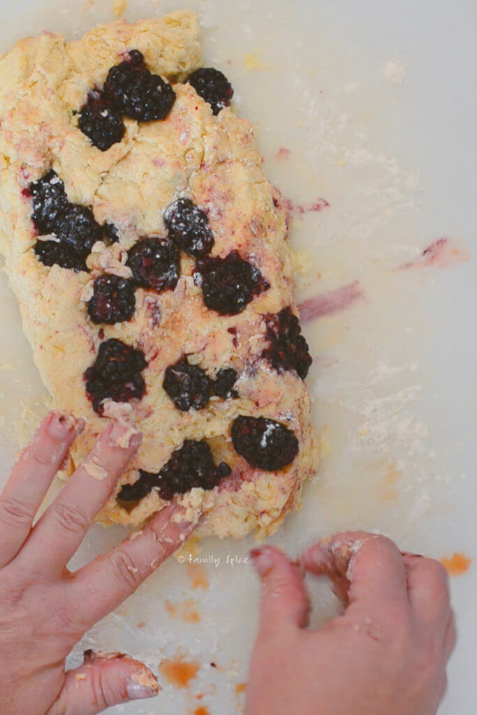 Pressing blackberry mixture into scone dough