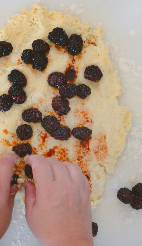 Adding balsamic blackberry mixture into scone dough