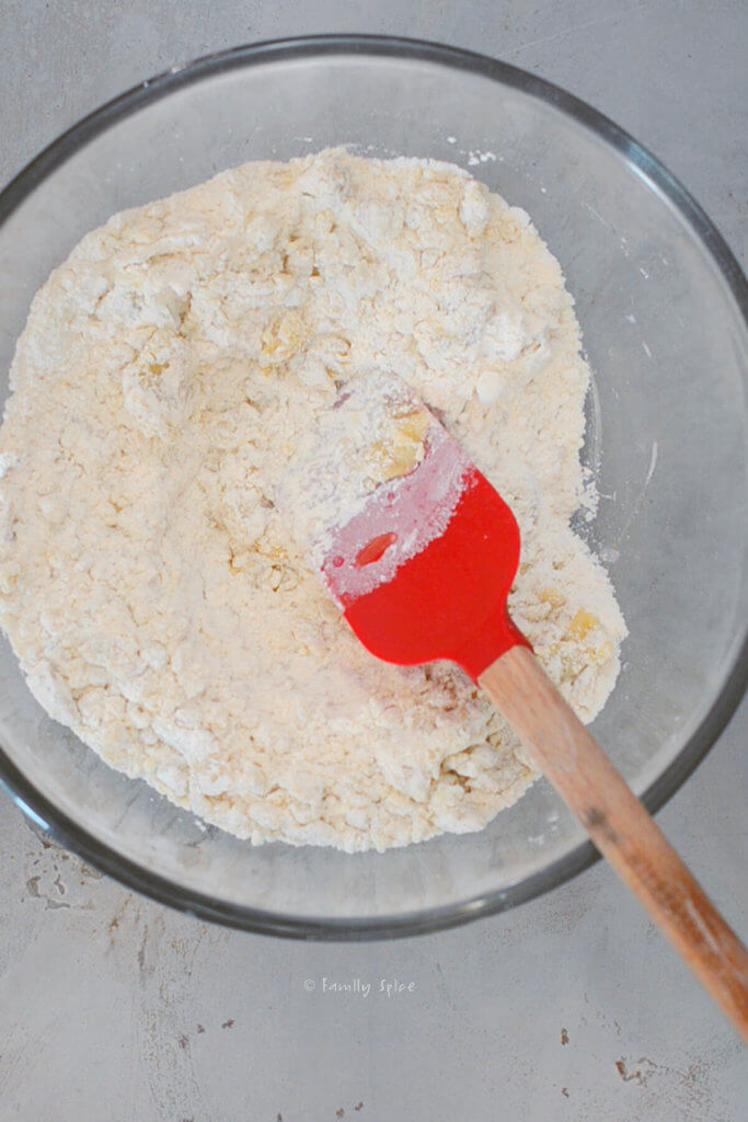 Combining olive oil and flour in a glass mixing bowl