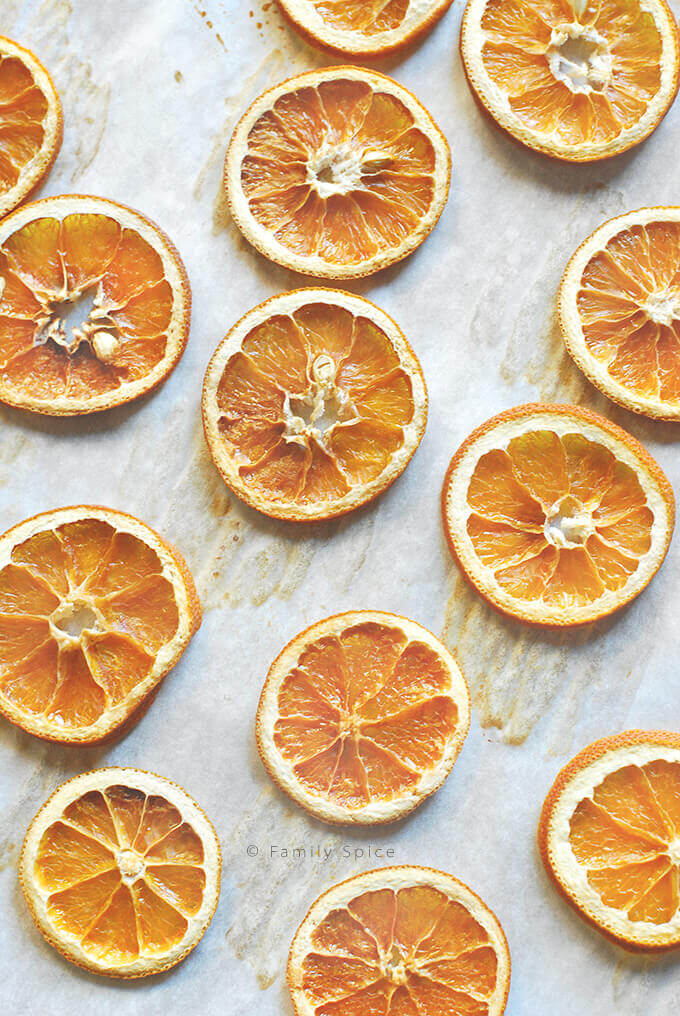 Oven dried oranges on a baking pan by FamilySpice.com