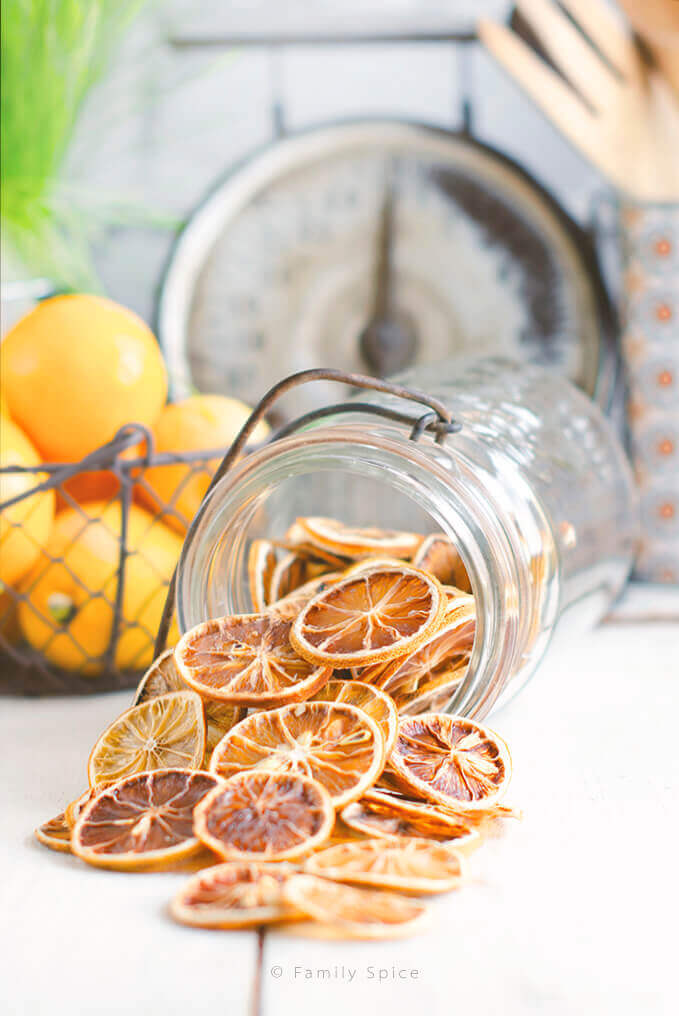 Oven dried lemons in a jar, spilled on a counter by FamilySpice.com