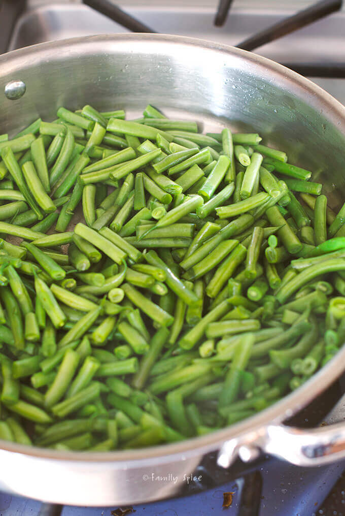 Chopped string beans in a frying pan by FamilySpice.com