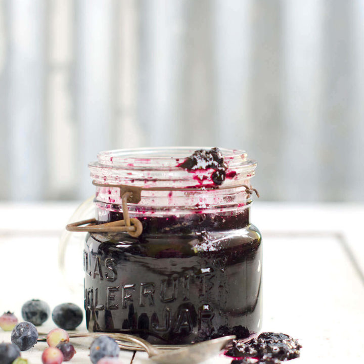 An antique mason jar with blueberry honey jam