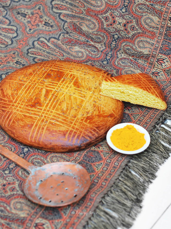 Freshly baked shirin chorek (sweet Persian bread) with a wedge slice next to it