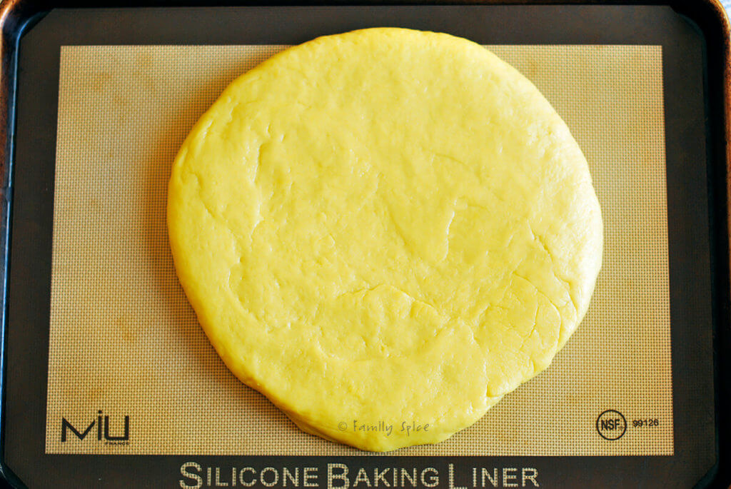 Shirin chorek dough flattened on a baking sheet lined with a silicon mat