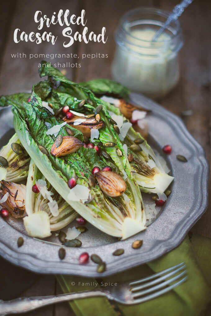 Closeup of a dish with Grilled Caesar Salad with pomegranate, pepitas and shallots by FamilySpice.com