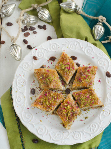 Persian Baklava with Raisins, Pistachios, Almonds and Rosewater formed to make a star on a white plate