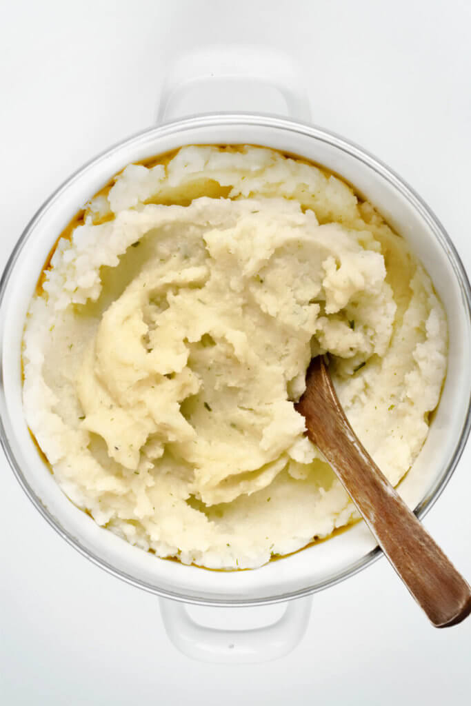 Mashed potatoes in a white pot on a white background