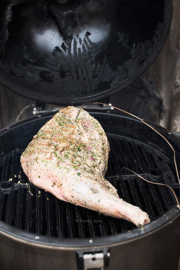 A marinated leg of lamb placed on a grill