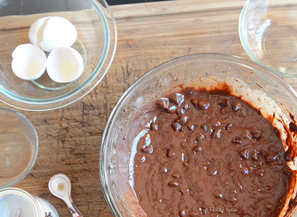 Mixing up brownie cookie batter in a glass mixing bowl