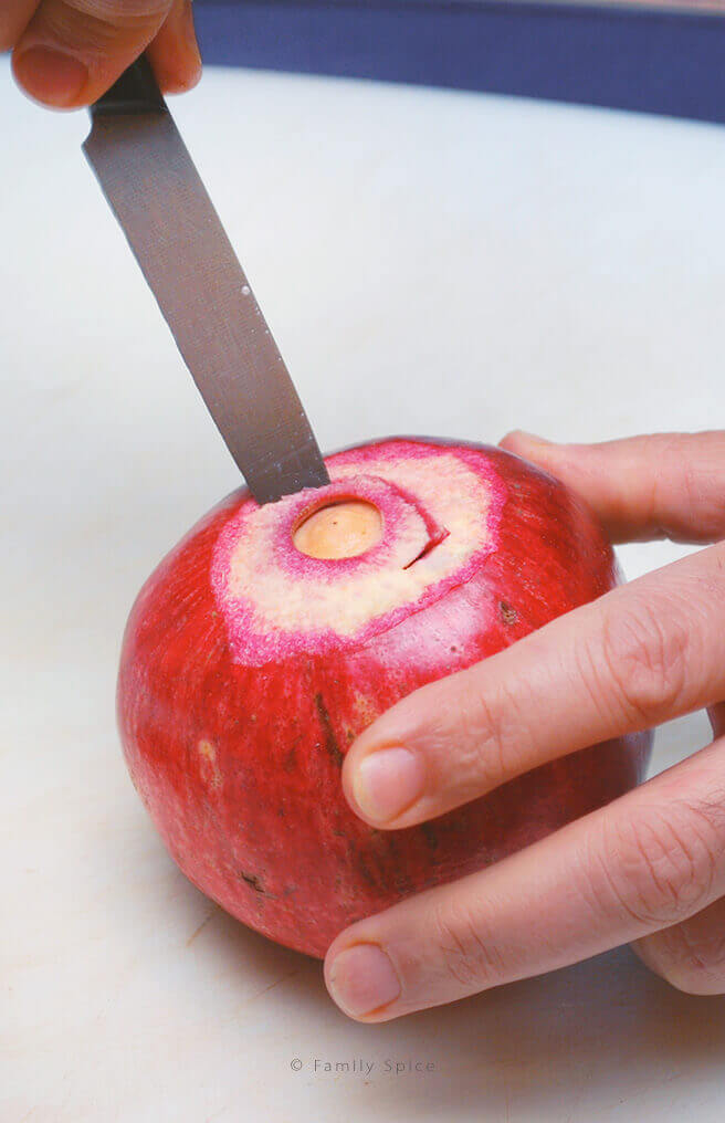 Cutting out the center pith from a pomegranate by FamilySpice.com