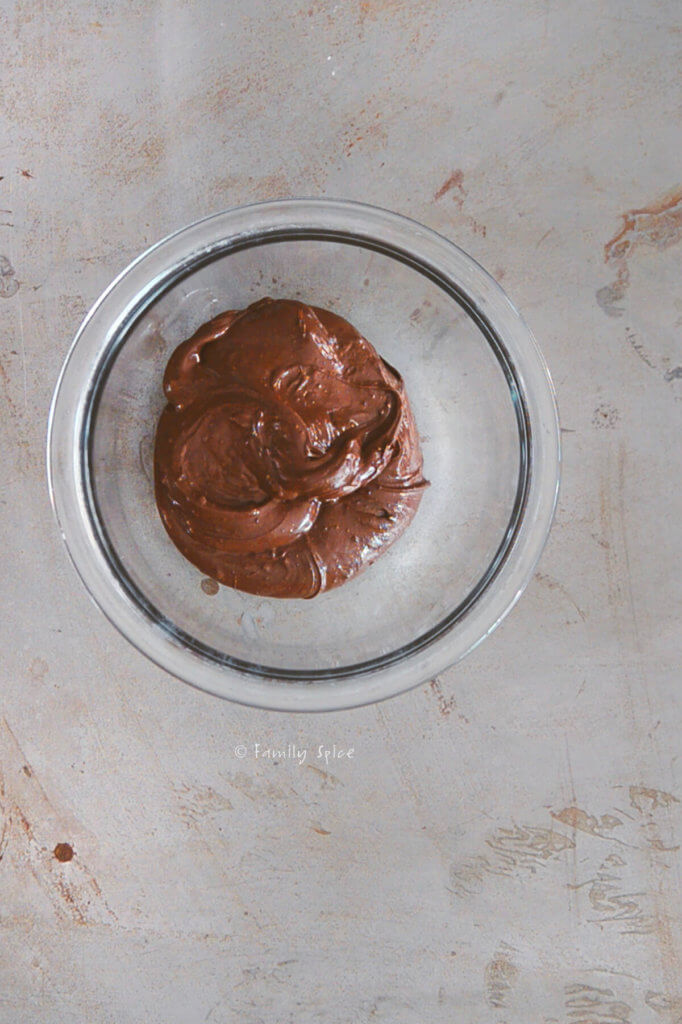 Chocolate melted in a small glass bowl