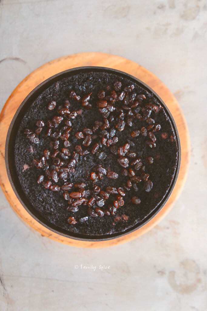 Top view of a chocolate cake with liqueur soaked raisins