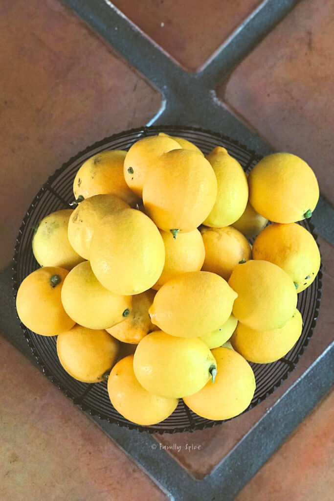 Top view of a black metal bowl filled with homegrown lemons