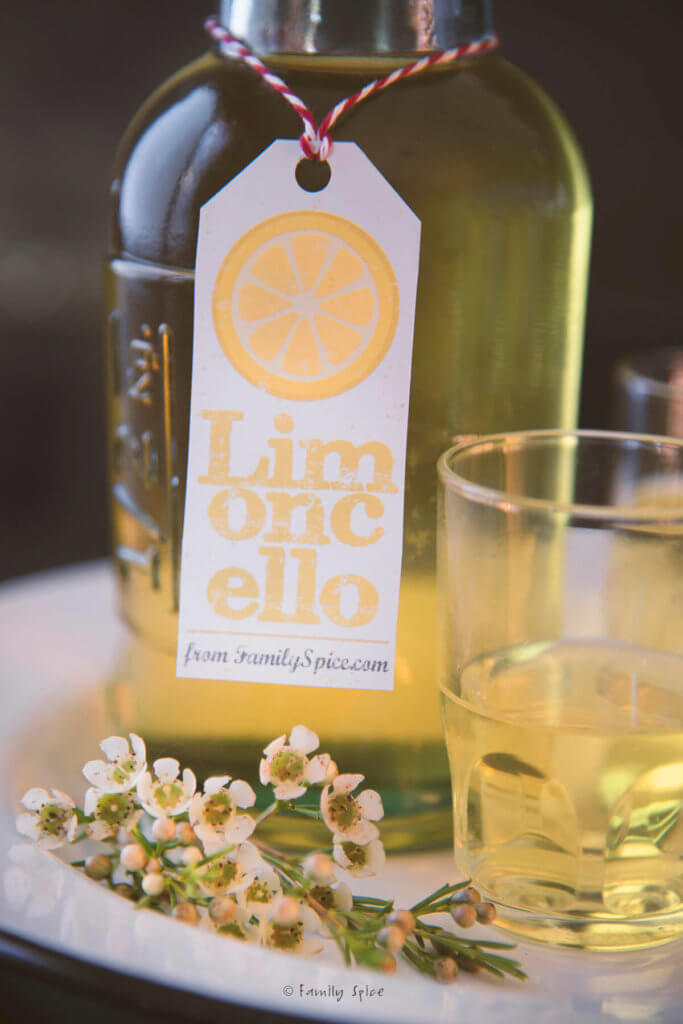 Closeup of a bottle of homemade limoncello with a free printable limoncello label