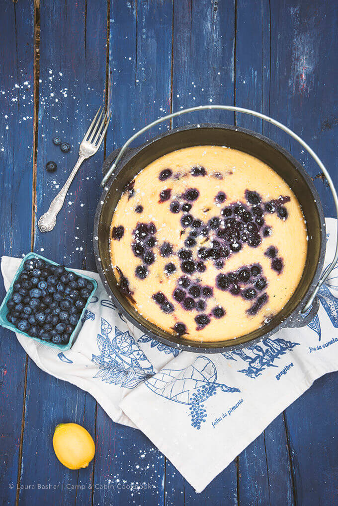 Dutch Oven Lemon Blueberry Clafoutis from The Camp & Cabin Cookbook by Laura Bashar (familyspice.com)