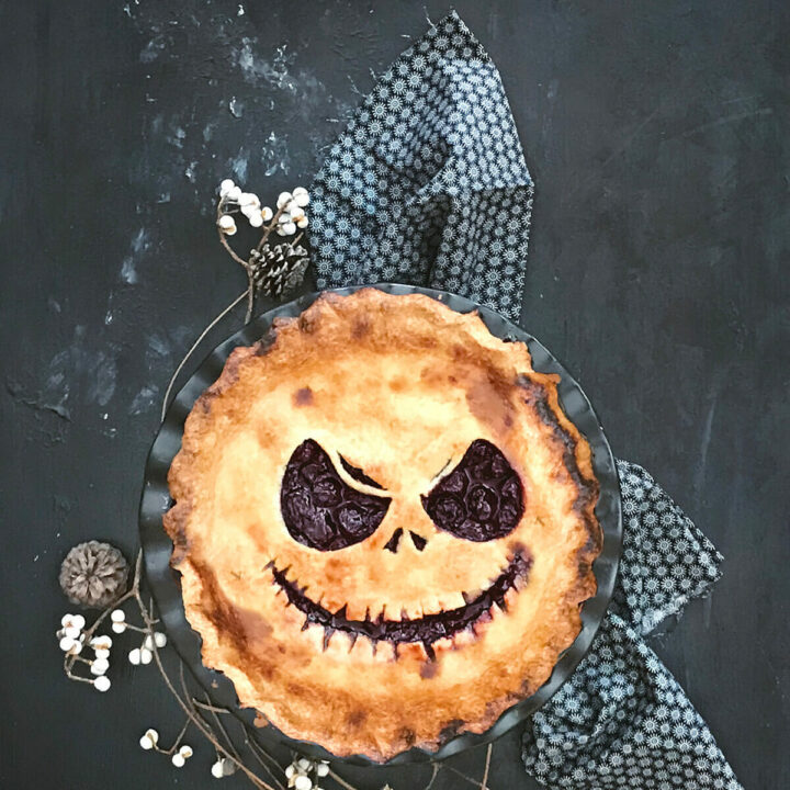 Top view of a halloween pie cut to show Jack Skellington in the crust