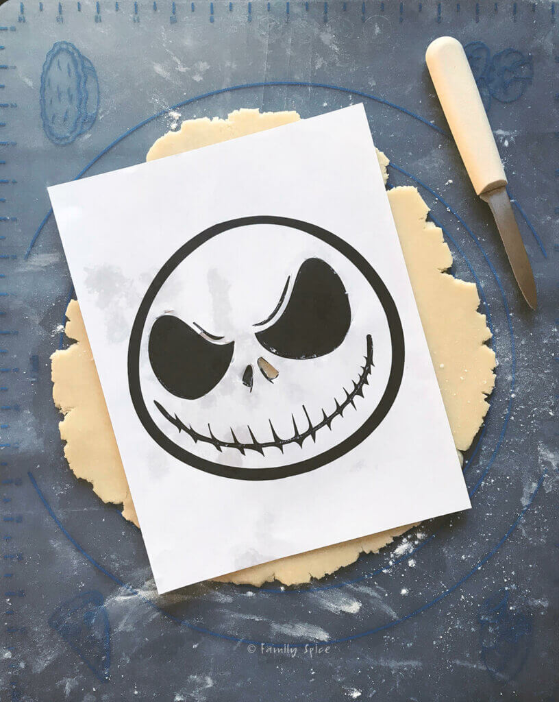 A printout of Jack Skellington's face on top of a rolled out pie dough