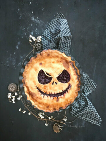 Top view of a halloween pie cut to show Jack Skellington in the crust